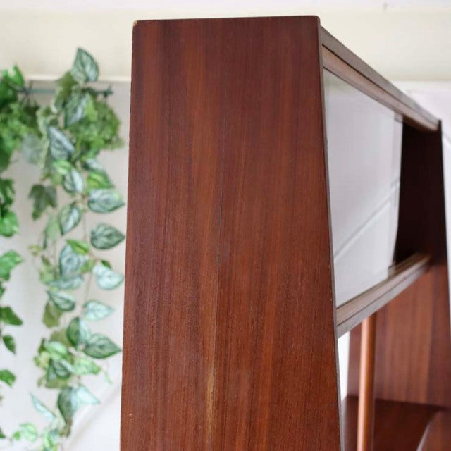 Mid-century vintage teak room divider with sleek British design, showcasing fine wood grain and iron legs from Denmark.