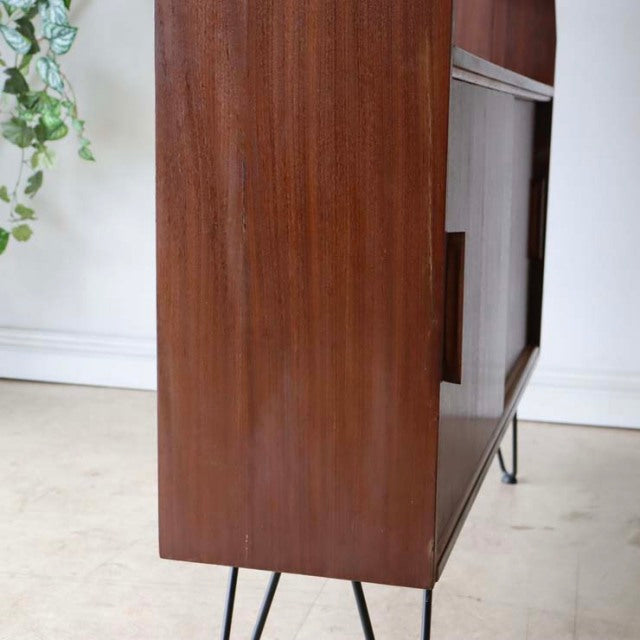 Vintage mid-century teak room divider with smooth wood grain and slender British iron legs from Denmark.