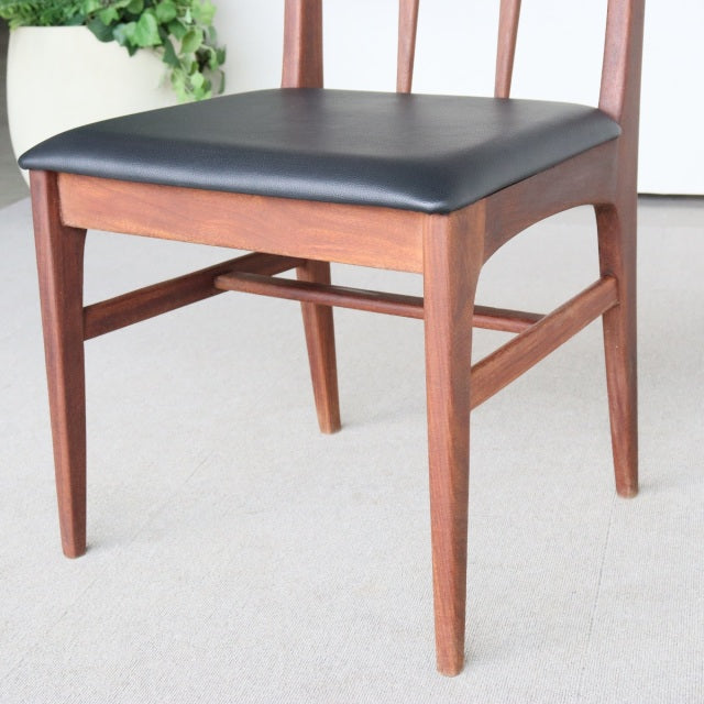 Mid-century vintage teak dining chair by Younger with black leatherette cushioned seat and slender tapered legs,.