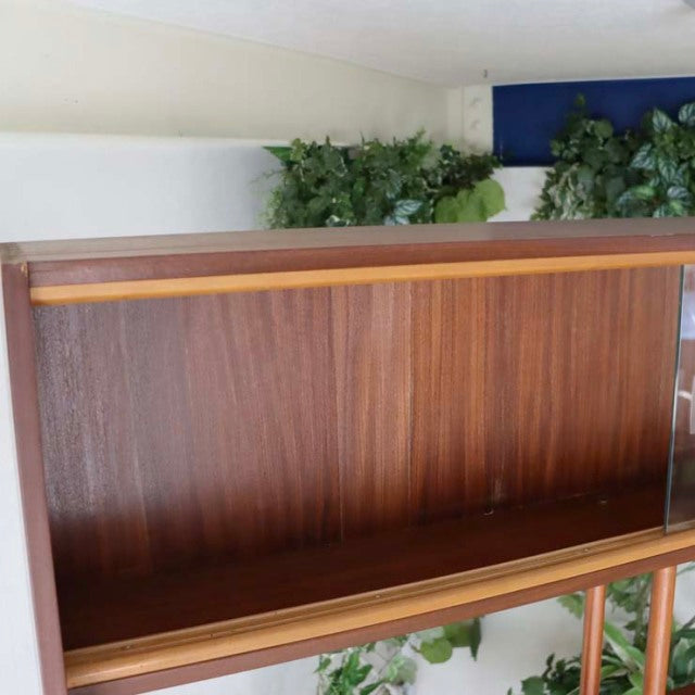 Vintage teak room divider with rich wood grain, British mid-century design, and iron legs from Denmark.