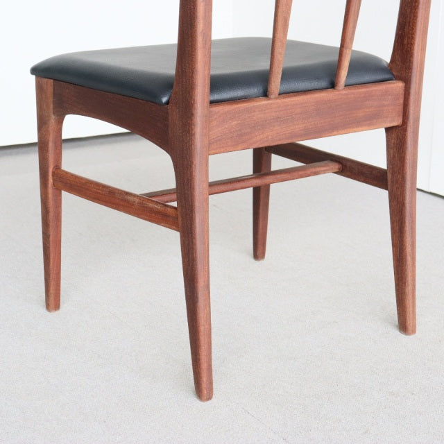 Mid-century teak dining chair with black faux leather seat, British Younger FONSECA series, slender tapered legs and visible .