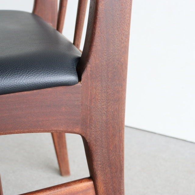 Mid-century British teak dining chair with sleek curved legs and black vinyl seat upholstery from Younger Fonseca series.