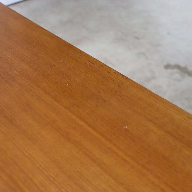 Close-up of vintage teak wood grain on mid-century British-Denmark TV board surface with smooth finish.