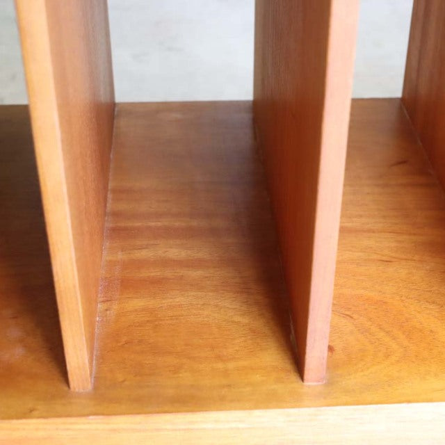 Close-up of vintage teak wood grain on mid-century British-Denmark TV board dividers with smooth natural finish.