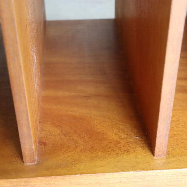 Close-up of vintage teak wood grain and paneling on mid-century British-Denmark style TV board interior compartment.