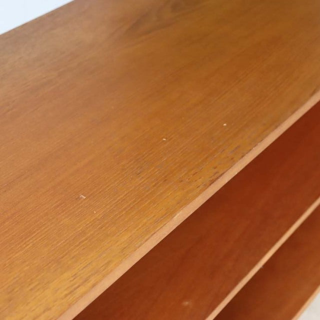 Mid-century vintage teak TV board with rich wood grain and open shelving, showcasing British-Denmark design.