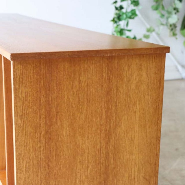 Mid-century British vintage teak TV board with smooth wood grain and iron legs, sleek rectangular form.