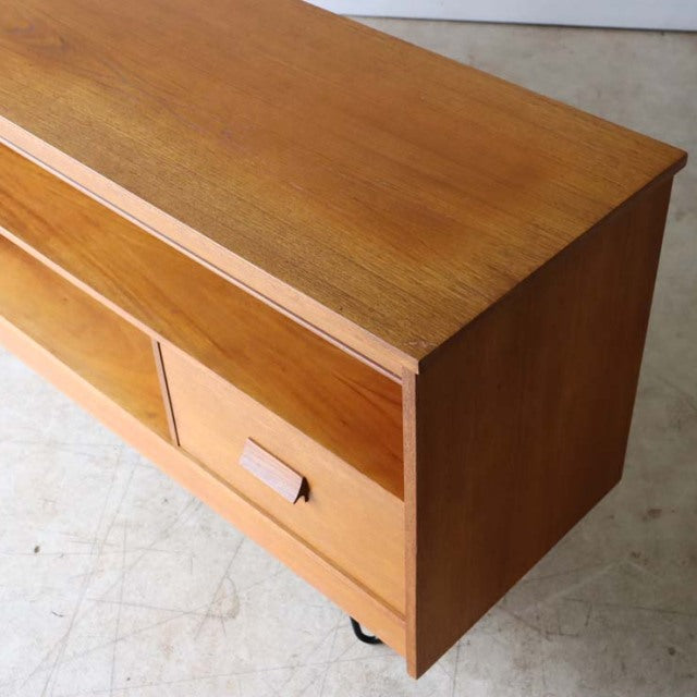 Mid-century British vintage teak TV board with smooth wood grain, rectangular shape, and minimalist drawer handle.