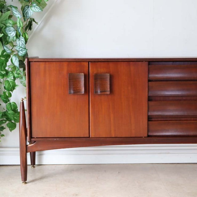 Mid-century British vintage sideboard by Elliotts of Newbury in warm teak with rich wood grain, featuring curved rectangular .