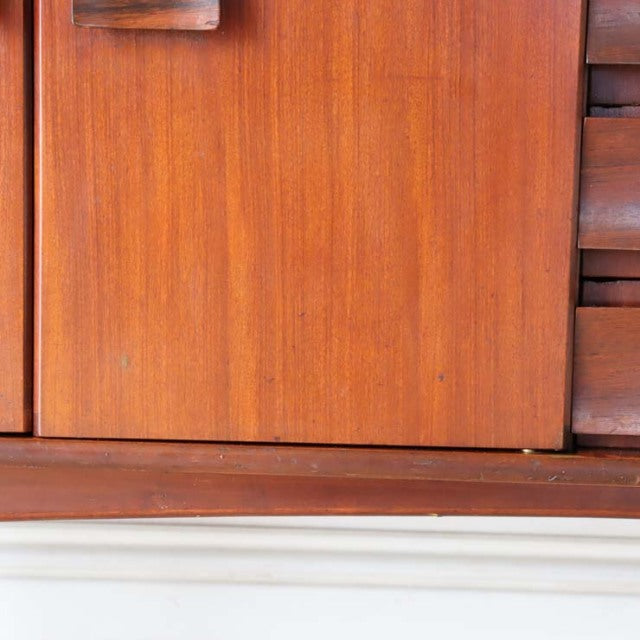 Close-up of mid-century British vintage teak sideboard door with rich wood grain and smooth finish.