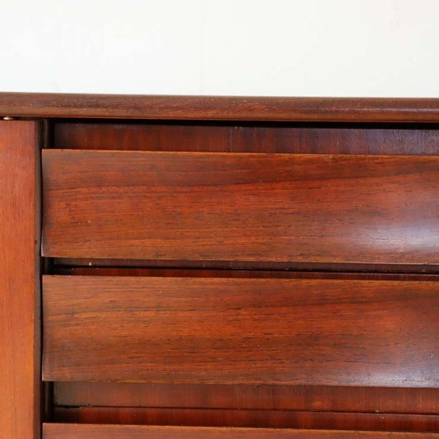 Close-up of vintage British mid-century teak sideboard drawers showing rich wood grain and smooth curved fronts by Elliotts.