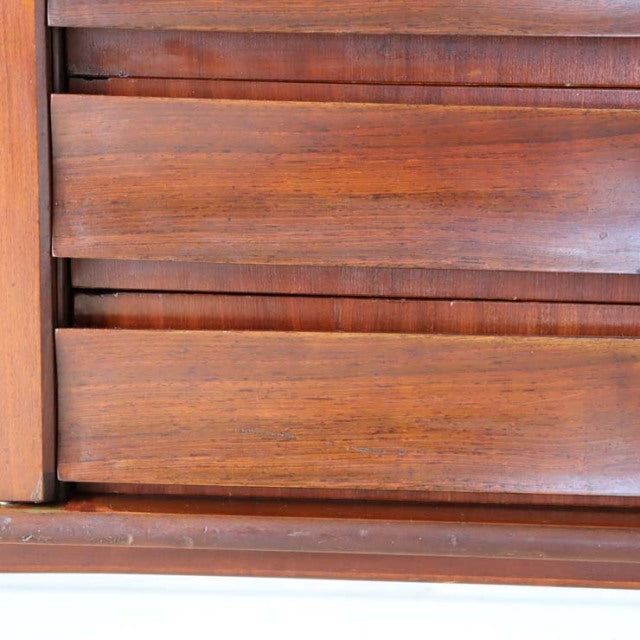 Close-up of teak wood grain and smooth rounded drawer fronts on vintage British mid-century Elliott of Newbury sideboard.