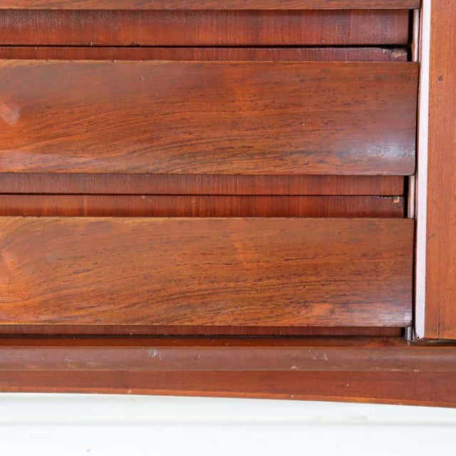 Close-up of vintage British mid-century teak wood sideboard drawer front showing rich wood grain and smooth polished finish.