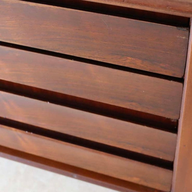 Close-up of vintage teak sideboard drawers displaying rich wood grain with smooth mid-century British design and clean lines.