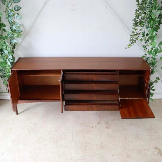 Vintage mid-century teak sideboard by Elliotts of Newbury, British design with floating-style legs, rich wood grain, three.