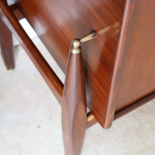 Mid-century British teak sideboard leg with brass detail and rich wood grain, vintage Danish style.
