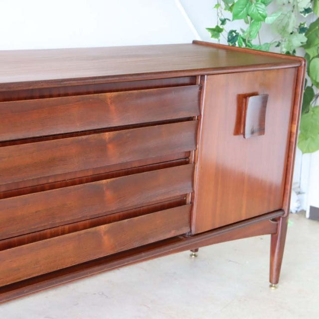 Mid-century British vintage teak sideboard by Elliotts of Newbury with zebrano wood door, four drawers, and slender tapered.