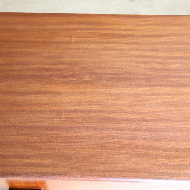 Top view of vintage mid-century teak wood sideboard surface with warm wood grain, crafted by British brand Elliotts of.