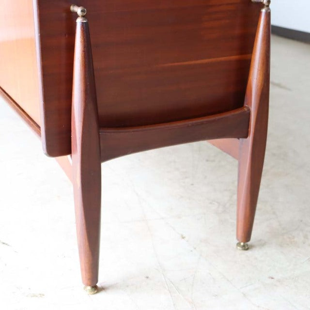 Mid-century British vintage teak sideboard leg with distinctive tapered design and brass-capped feet, showcasing rich wood.