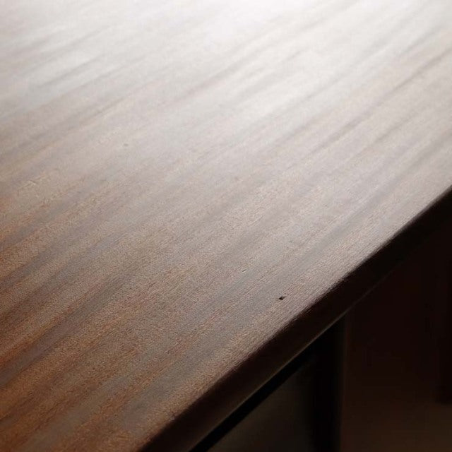 Close-up of vintage British mid-century teak sideboard top showcasing smooth wood grain and rich warm tones.