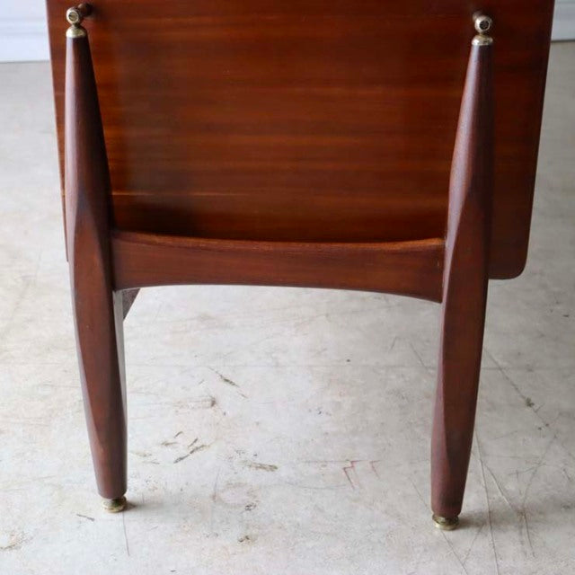 Mid-century British teak sideboard leg detail with rich wood grain and brass-capped feet from Elliotts of Newbury.