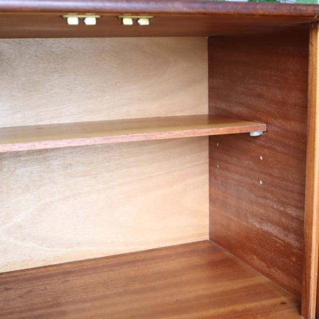 Interior view of vintage British mid-century teak sideboard with adjustable shelf and rich wood grain from Elliotts of.