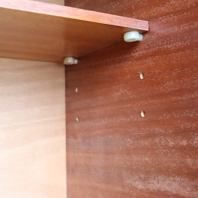 Close-up of teak wood interior panel with vintage screw holes and bracket, mid-century British craftsmanship details.