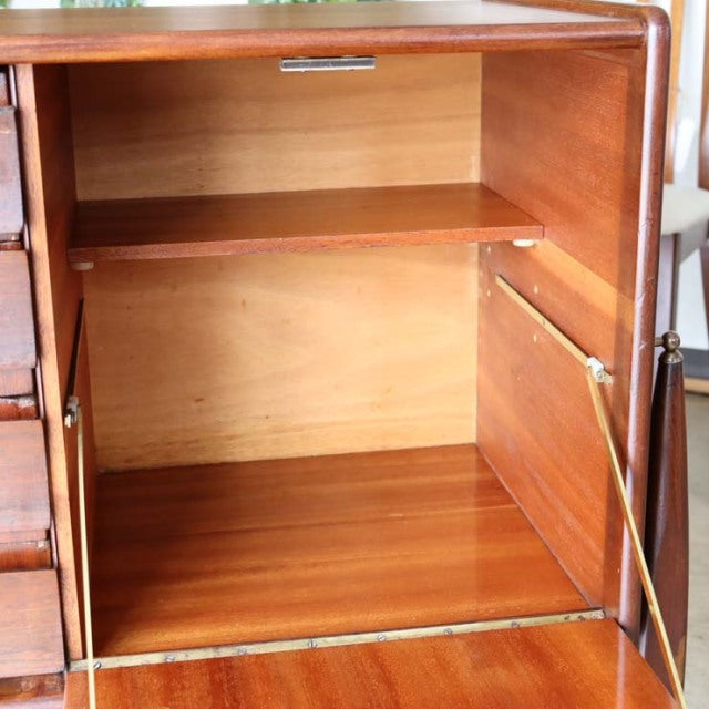 Vintage British mid-century teak sideboard with open cabinet door, showcasing smooth wood grain and sleek floating-style legs.