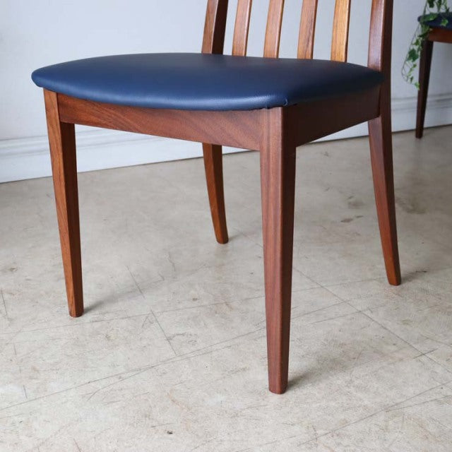 Mid-century British G-PLAN Fresco teak dining chair with dark blue upholstered seat and tapered legs.