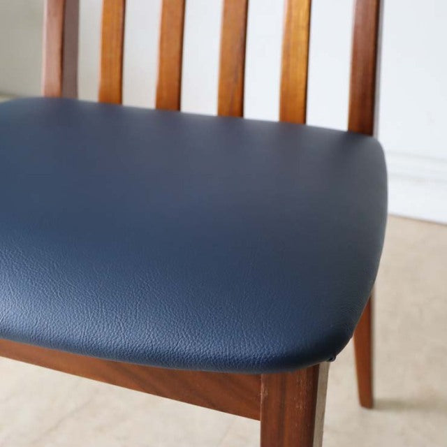 Set of four vintage British mid-century G-PLAN Fresco dining chairs with teak frames and navy leather seats.