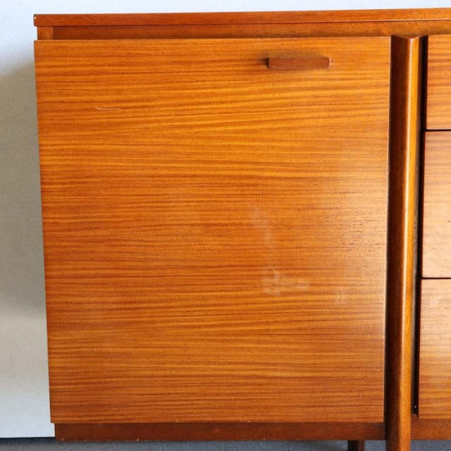 Mid-century vintage British teak sideboard with rich wood grain, smooth finish, and minimalist handle detail.