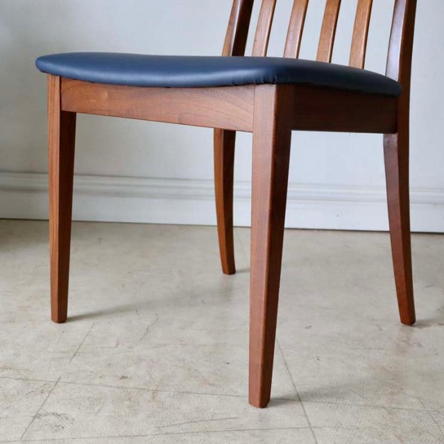 Set of four vintage G-PLAN Fresco dining chairs in mid-century teak with navy upholstered seats and slender legs.
