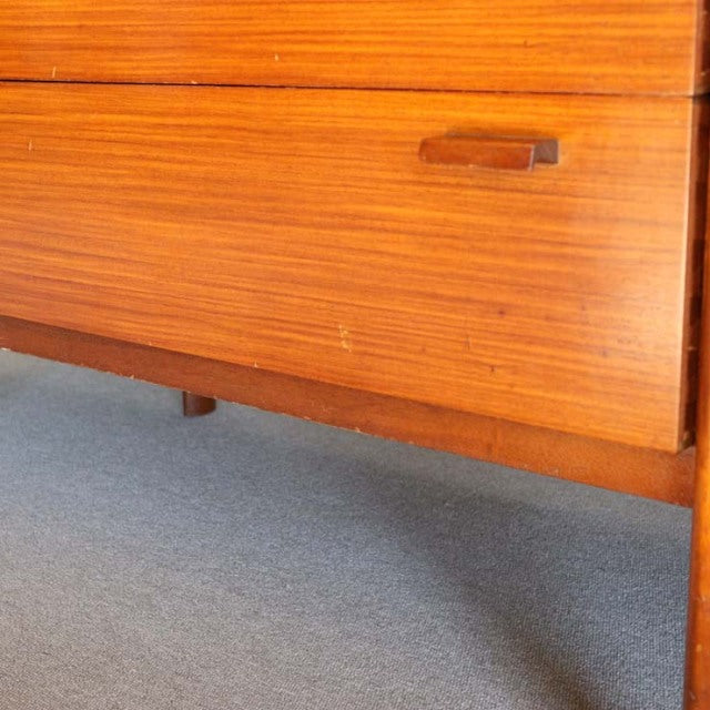 Mid-century British vintage teak sideboard with horizontal wood grain, sleek handle, and tapered legs showcasing Danish.