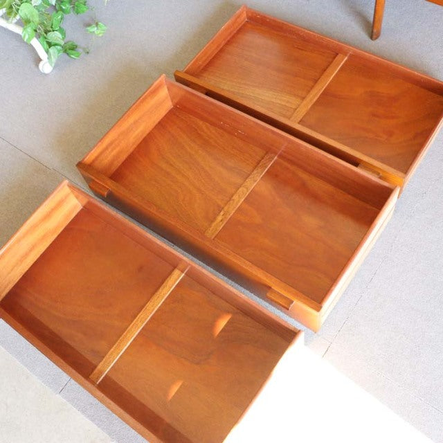 Vintage teak British sideboard drawers with rich wood grain and mid-century Danish design details.
