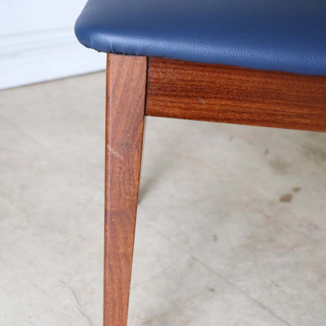 Mid-century British G-PLAN Fresco dining chair leg in rich teak wood with visible grain and navy blue upholstered seat.