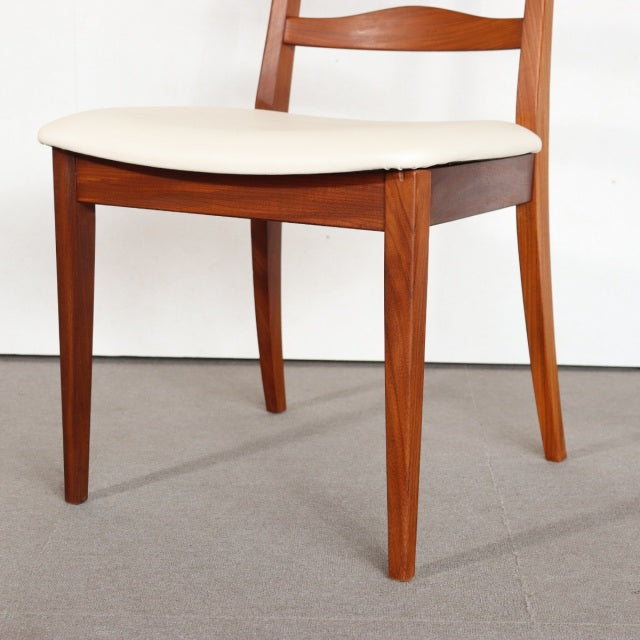 Vintage British mid-century G-PLAN dining chair in teak with smooth wood grain, curved backrest, and white cushioned seat.