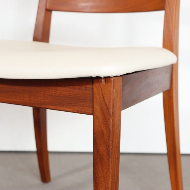 Vintage G-Plan teak dining chair with cream upholstered seat, tapered legs, and mid-century British design influences from.