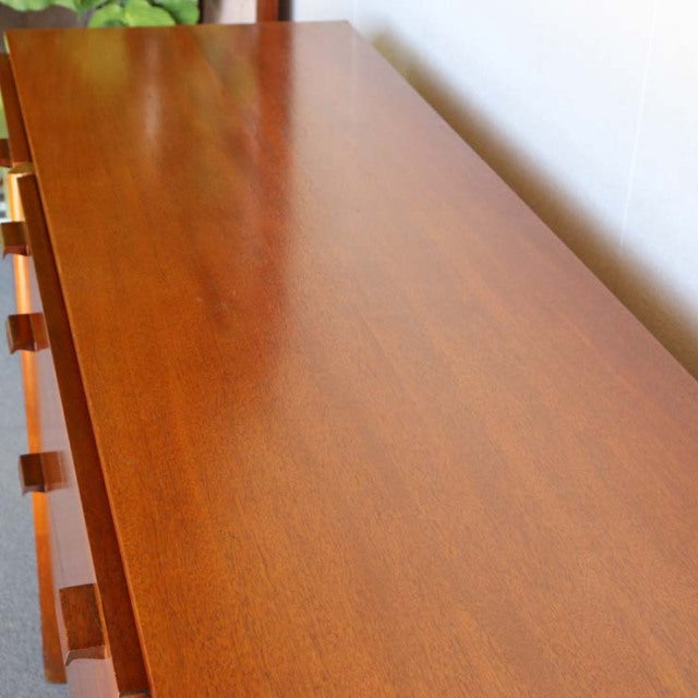 Vintage mid-century teak sideboard with smooth grain, clean lines, and tapered British-style legs.