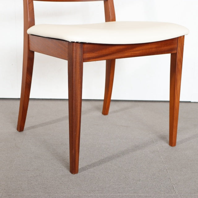 Vintage British G-PLAN dining chair in teak with mid-century clean lines and cream upholstered seat, showing smooth wood.