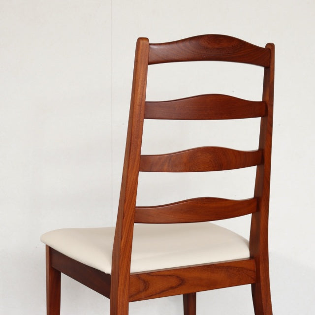 Vintage British mid-century G-PLAN dining chair in teak with curved ladder back and cream upholstered seat.