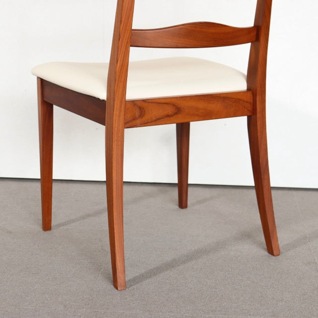 Mid-century British G-PLAN dining chair in vintage teak with tapered legs and cream upholstered seat.