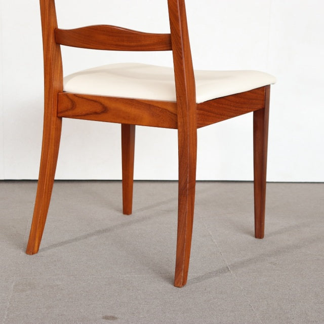 Vintage teak G-Plan dining chair with British mid-century design, sleek tapered legs, and cream upholstered seat.