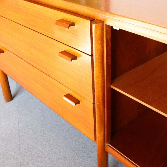 Vintage mid-century teak sideboard from British-Denmark design, featuring smooth wood grain, three drawers with rectangular.
