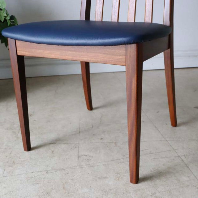 Set of four vintage G-PLAN Fresco dining chairs in teak with sleek mid-century British design and dark navy leather seats.