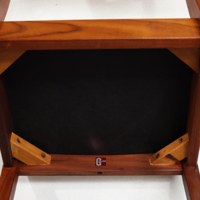 Underside view of vintage British mid-century teak G-PLAN dining chair showing wood grain, sturdy legs, and frame details.