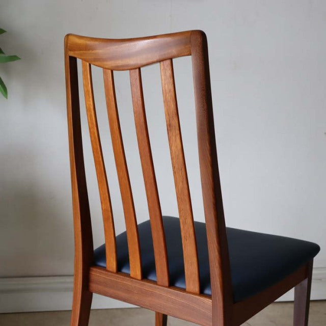 Mid-century vintage British G-PLAN Fresco dining chair with teak frame, vertical slat back, and dark navy upholstered seat.