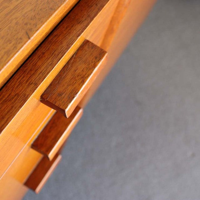 Close-up of vintage British mid-century teak sideboard drawer with rich wood grain and rectangular handles.