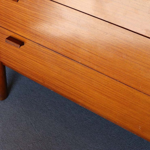 Vintage British mid-century teak sideboard with smooth wood grain and rounded legs, Denmark style.