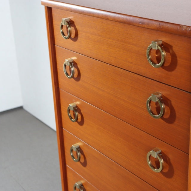 Mid-century British vintage teak chest with five drawers, brass ring handles, and warm wood grain detailing from Austinsuite.