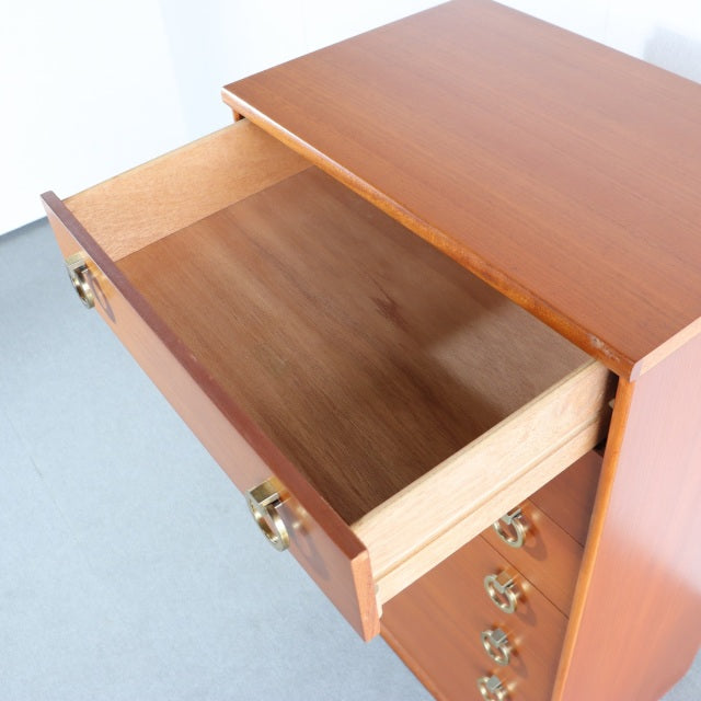 Mid-century British vintage teak chest from Austinsuite with brass ring handles, smooth wood grain, and tapered legs, drawer .